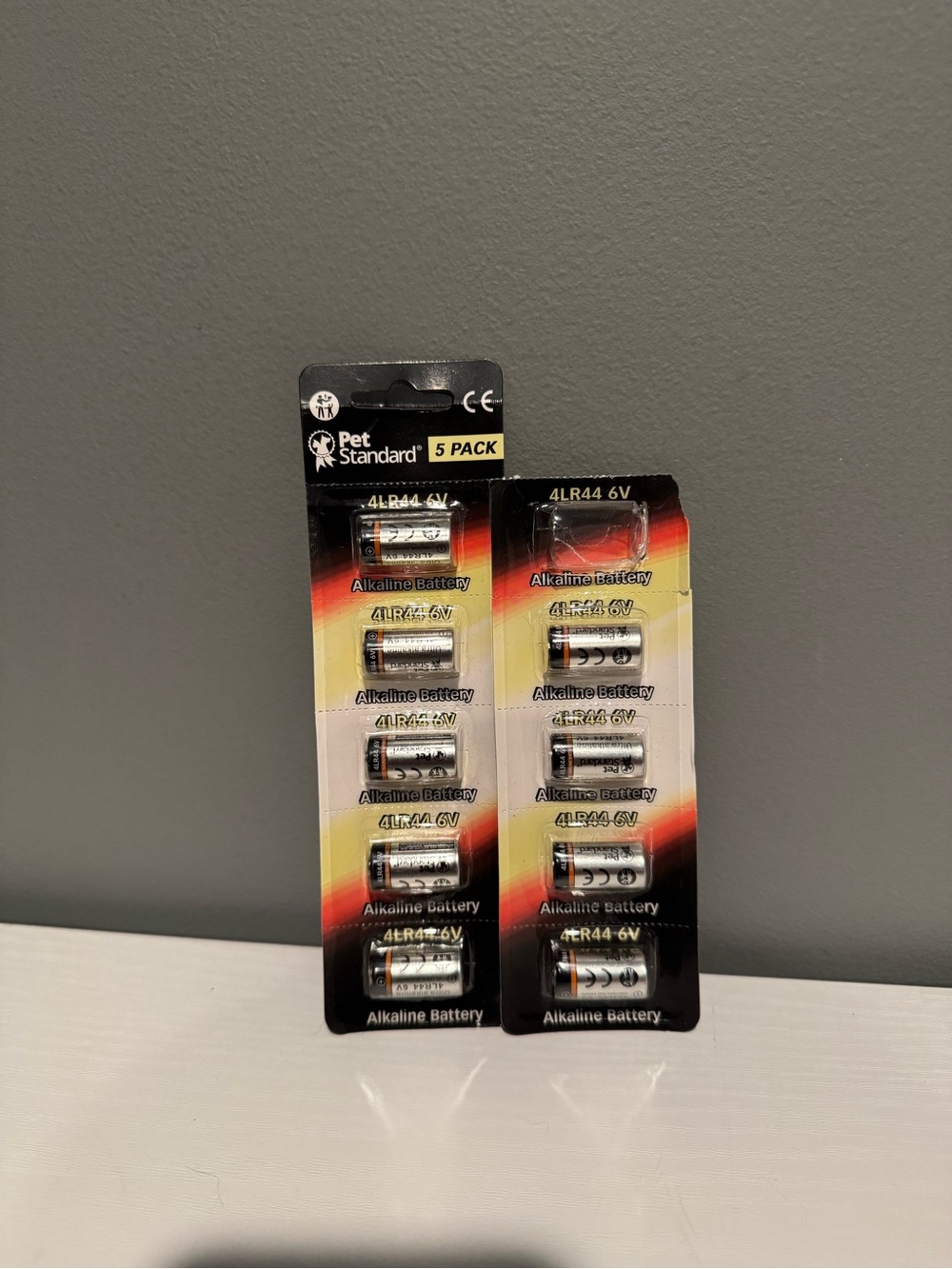 4LR44 6V Alkaline Battery Pack - Black/Silver (5 Pack) and 4 pack with one gone